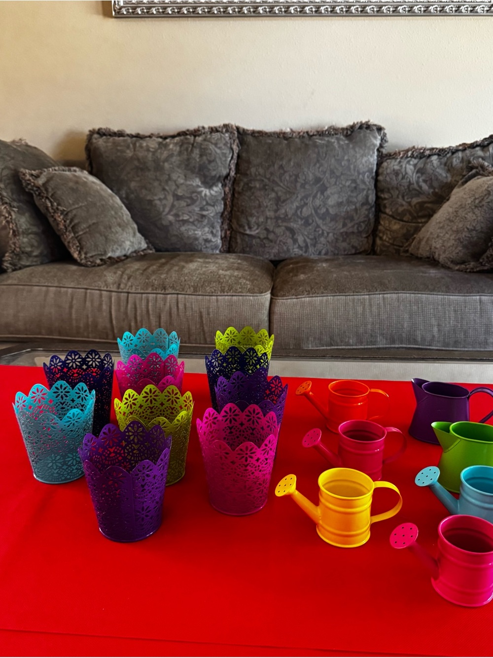 multicolor pails and tiny water and cans